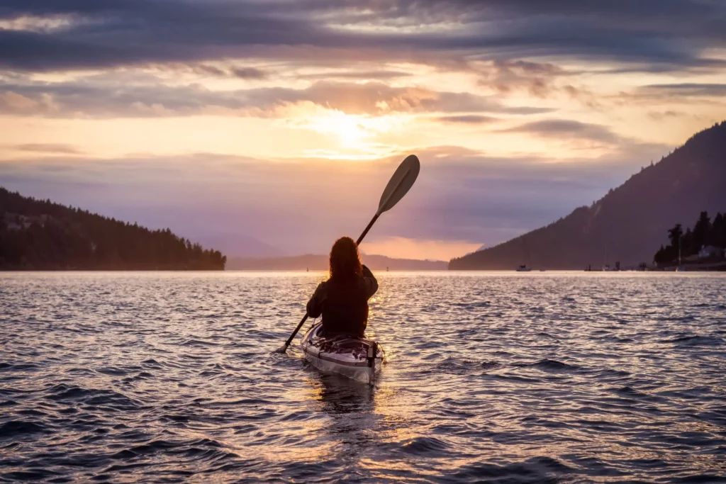 An adventurous woman kayaking in a lake-Popular sit on top kayak