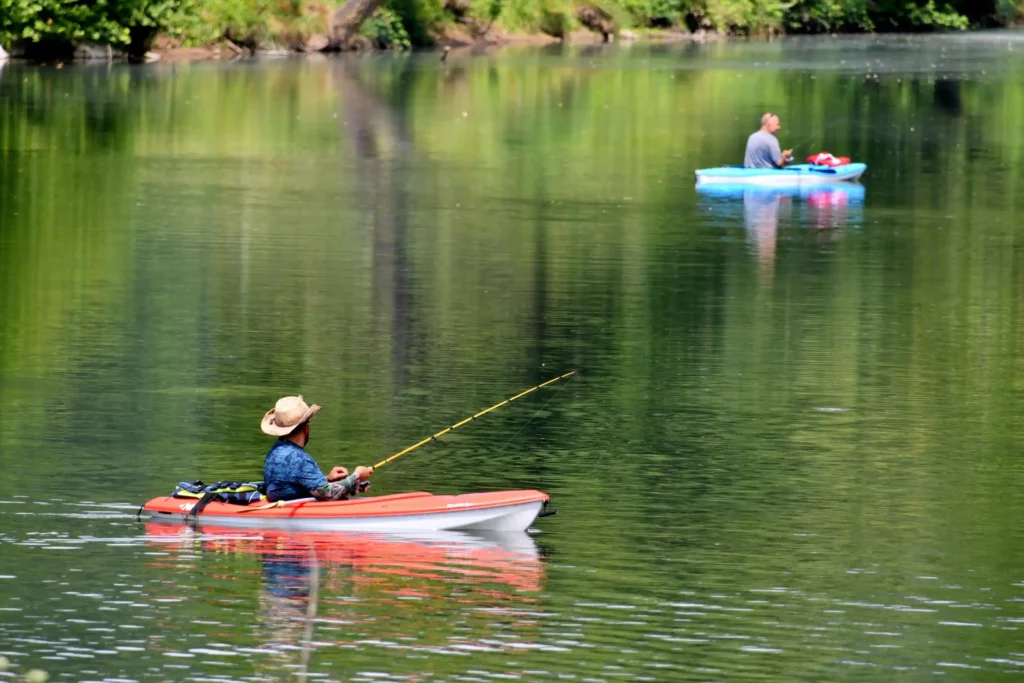 Men fishing from their kayaks on a river- the best stand up kayak for fishing