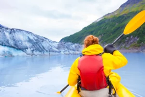 Young woman kayaking in Alaska-Best clothing for kayaking and canoeing