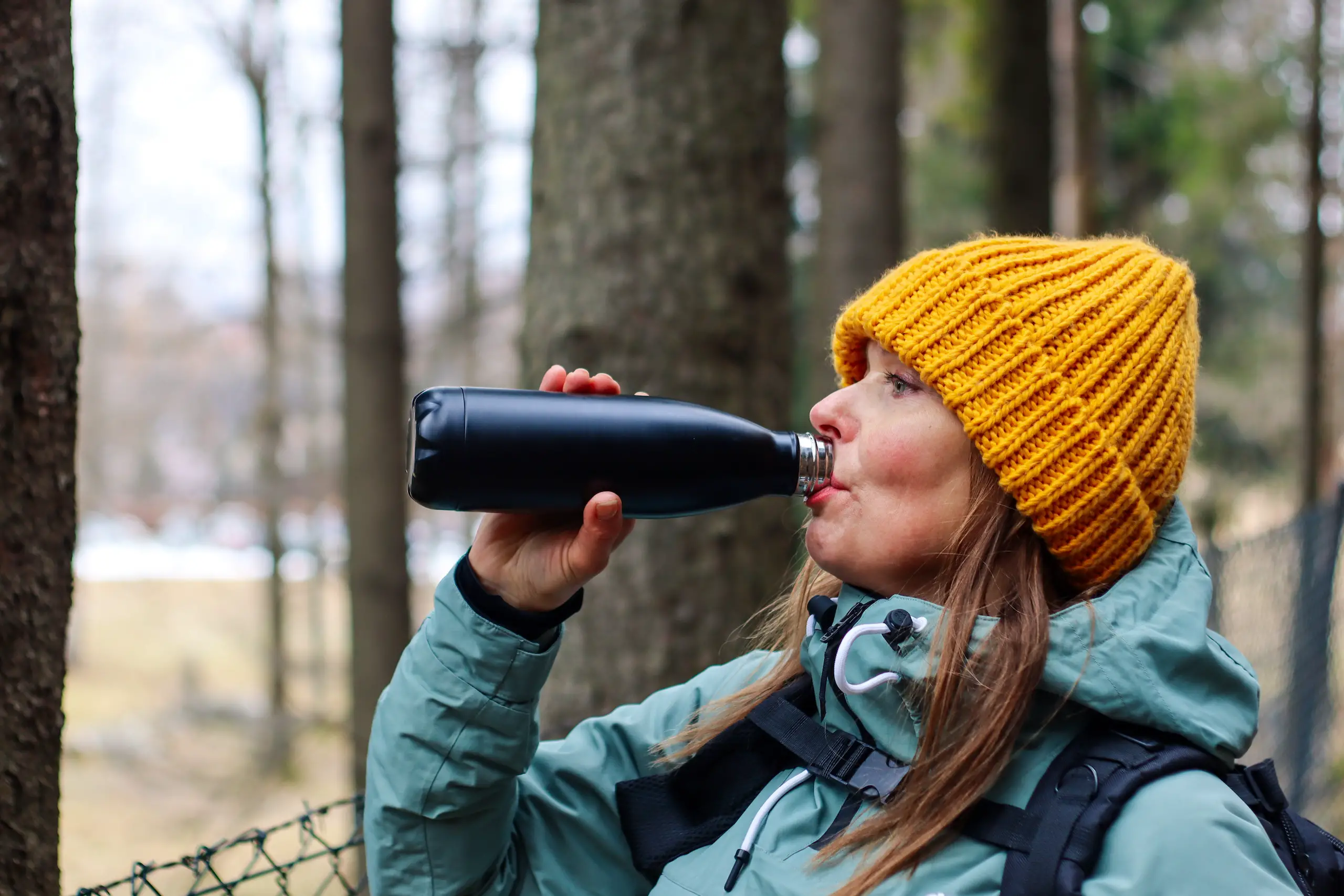 Woman drinking in a water bottle for hiking