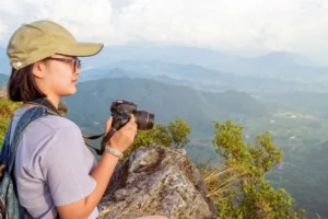 Hiker teen girl holding a camera for photography-Best camera for hiking